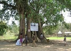A technology brief awareness poster at a village square at Belguri village